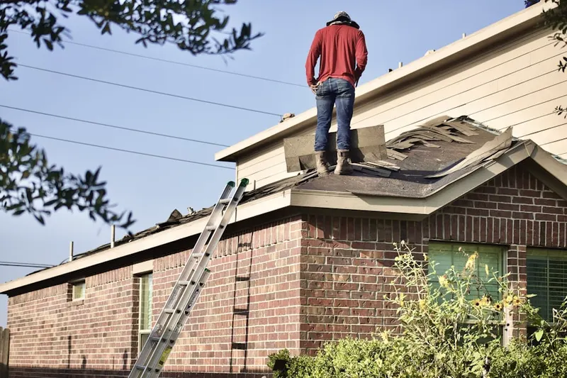 Professional roofer working on a residential roof in Valencia Acres